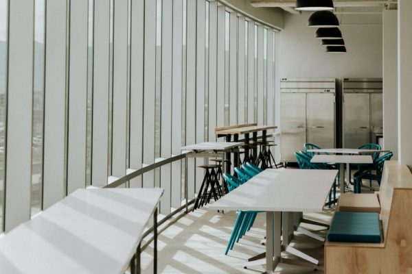 Dining room area with multiple refrigerators in commercial office kitchen